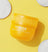Yellow container of "The Pads" ingrown hair eliminator pads with three white round pads on a yellow background.