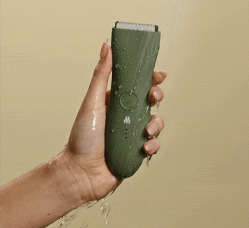 female hand holding waterproof body hair trimmer 