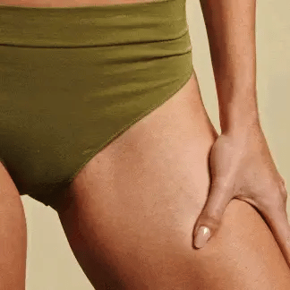 female trimming hair in groin area with Meridian trimmer