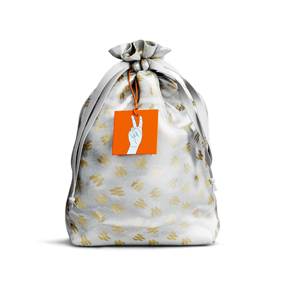 Drawstring pouch with gold pattern and an orange tag featuring a hand making a peace sign.