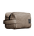Beige canvas Meridian grooming toiletry bag with a side handle and black zipper against a black background.