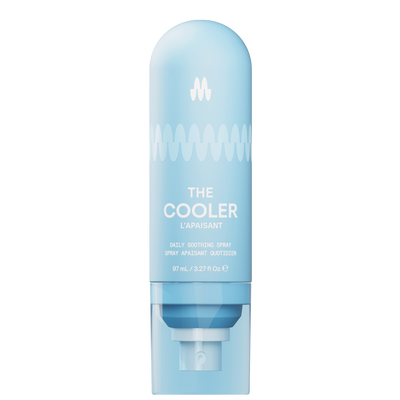 Back view of a light blue Meridian grooming spray bottle with usage directions and company information printed on it.