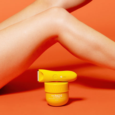 Close-up of legs with Meridian Grooming's The Pads for ingrown hair and an electric trimmer