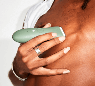person shaving chest hair with personal hair trimmer