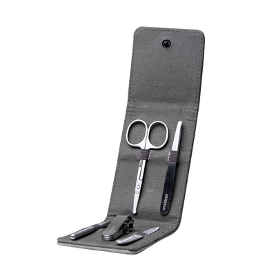 Compact men's grooming kit with scissors, tweezers, nail clippers, and a nail file in a gray fabric case.