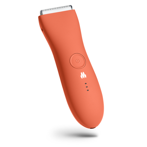 Electric orange trimmer for grooming with a power button and LED indicators.
