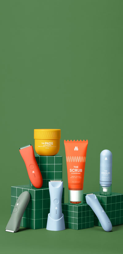 Skincare tubes and jars in orange, white, and green colors arranged on green cylindrical platforms with green background.