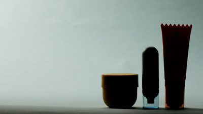 Silhouettes of three grooming product against a plain background.
