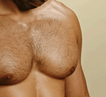Man using personal groomer to trim chest hair