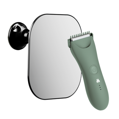 Electric trimmer in matte green with precision blades positioned next to a wall-mounted mirror.