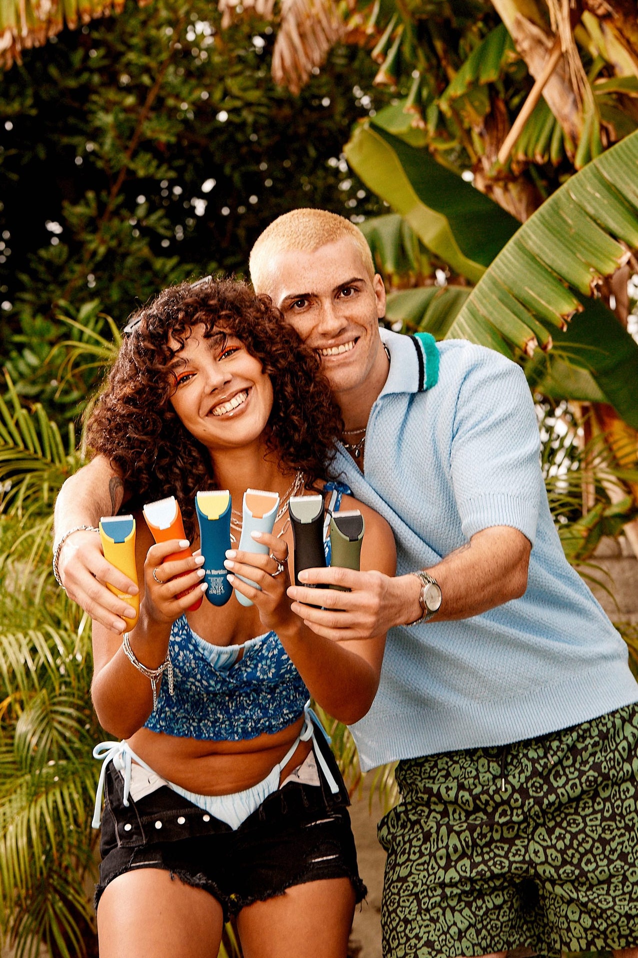 Happy couple holding the Meridian Trimmers in all the colors