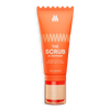 Orange exfoliating face scrub tube with gold and beige pump, labeled "The Scrub" for gentle skin renewal and detox.