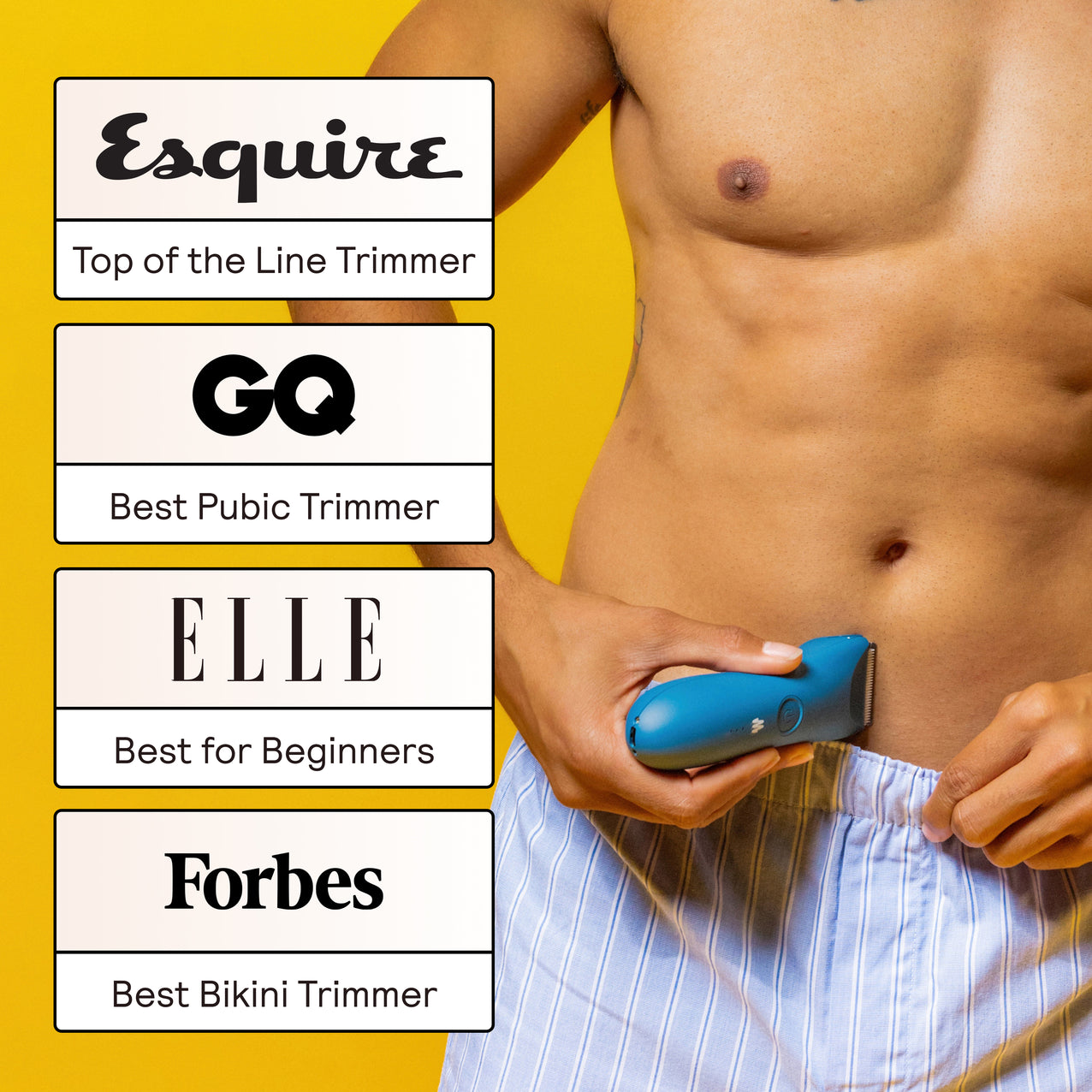 Shirtless man using blue electric pubic trimmer on lower abdomen, award-winning grooming tool by Esquire, GQ, Elle, Forbes.