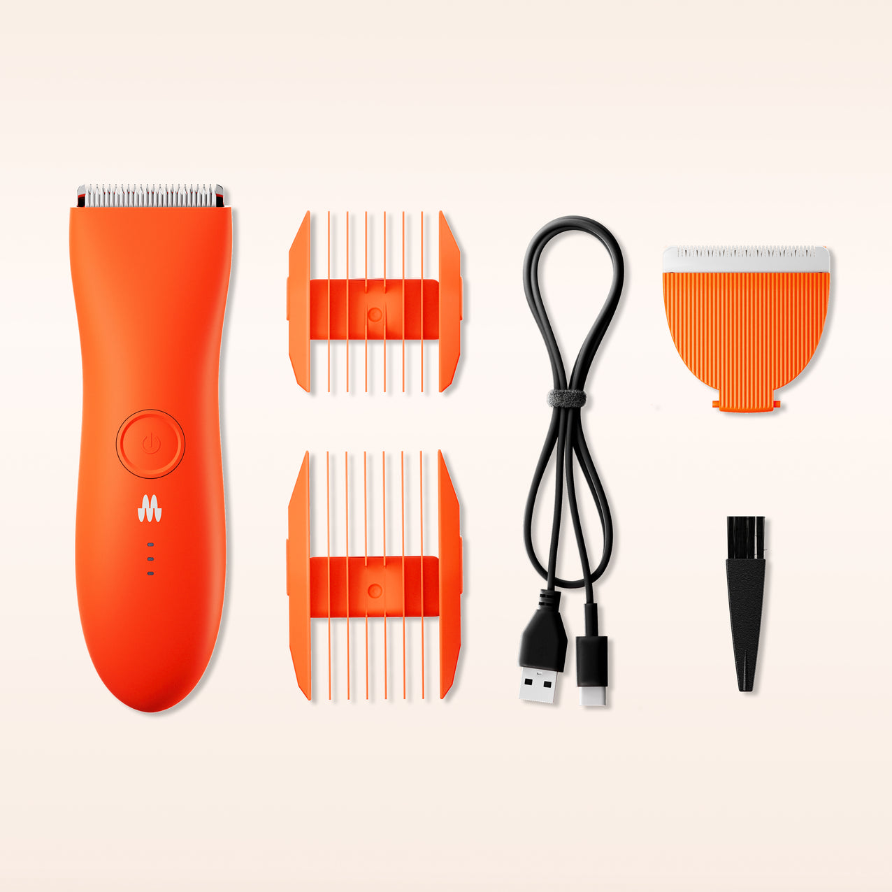 Orange electric hair clipper with two comb attachments, USB charging cable, detachable blade, and cleaning brush on white background.