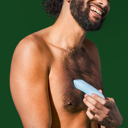 Man using the trimmer on his chest area