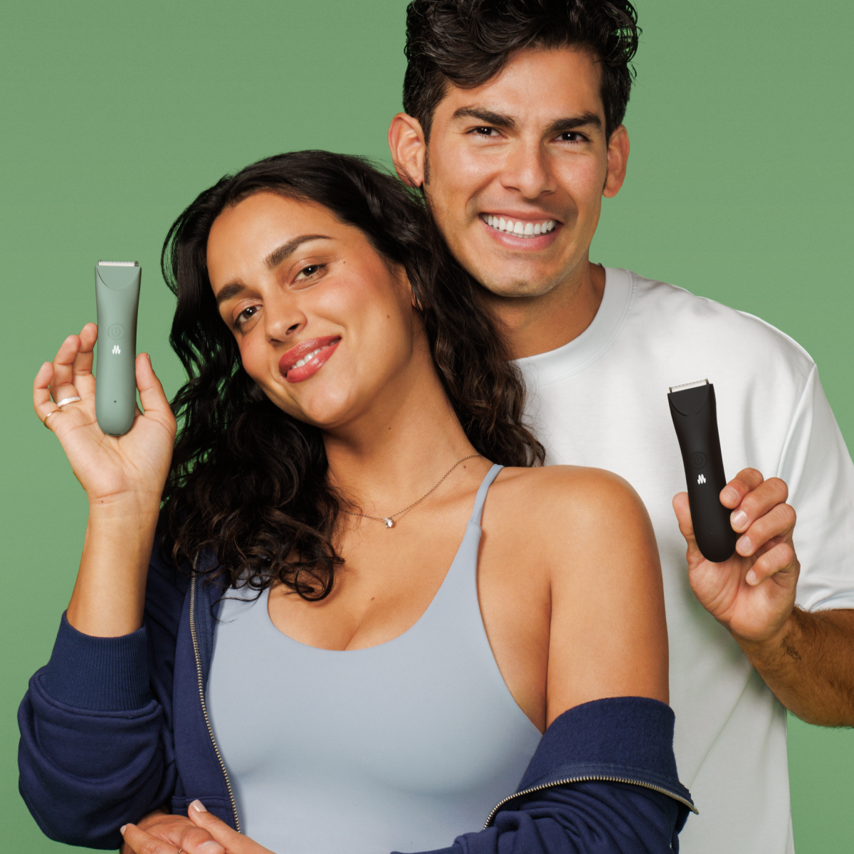 Happy couple holding Meridian Slimmer Trimmers — versatile grooming tools designed for both men and women
