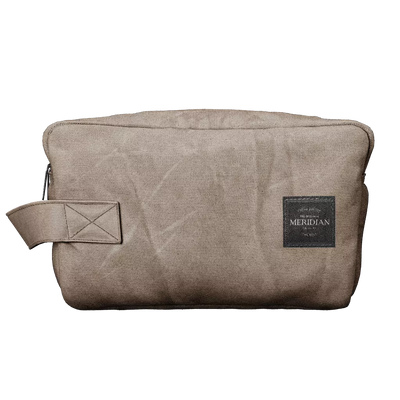 Beige fabric Meridian branded grooming essentials travel pouch with a side strap.